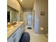 Double vanity bathroom with a large walk-in shower at 3300 Whitestone Cir # 306, Kissimmee, FL 34741