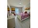 Cozy bedroom with floral bedding and adjacent bathroom at 3300 Whitestone Cir # 306, Kissimmee, FL 34741