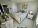 Spacious bedroom with a white bed frame and light wood floors at 3300 Whitestone Cir # 306, Kissimmee, FL 34741