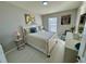 Bright bedroom with a white bed frame and light wood floors at 3300 Whitestone Cir # 306, Kissimmee, FL 34741