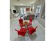 Open concept dining area with glass table and red chairs at 3300 Whitestone Cir # 306, Kissimmee, FL 34741