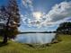 Serene lake view with lush landscaping and fountains at 3300 Whitestone Cir # 306, Kissimmee, FL 34741