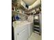 Bright laundry room with washer, dryer, and shelving at 3300 Whitestone Cir # 306, Kissimmee, FL 34741