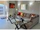 Modern living room with L-shaped sofa and glass-top tables at 3300 Whitestone Cir # 306, Kissimmee, FL 34741