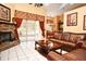 Living room with brick fireplace, leather furniture, and sliding glass doors at 4706 Beagle St, Orlando, FL 32818