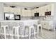 Modern kitchen featuring white cabinetry, stainless steel appliances, and a stone backsplash at 4707 Ross Lanier Ln, Kissimmee, FL 34758