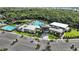 Aerial view of the clubhouse, pool, and surrounding trees at 5762 Le Marin Way, Kissimmee, FL 34758