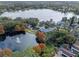 Aerial view of a residential community surrounding a scenic lake with a fountain at 631 Fallsmead Cir, Longwood, FL 32750