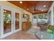 Screened porch with ceiling fan, ample seating, and access to the kitchen at 631 Fallsmead Cir, Longwood, FL 32750