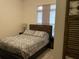 Bedroom featuring a stylish bed, patterned comforter, and window with blinds at 668 Nighthawk Cir, Winter Springs, FL 32708