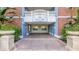 Entrance to a condo building with brick exterior, decorative urns, and a paved walkway at 7652 Whisper Way # 104, Reunion, FL 34747
