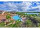 Aerial view of community pool and lakefront property at 8001 Cool Breeze Dr # 121, Orlando, FL 32819