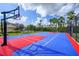 Outdoor basketball court with red and blue surface at 8001 Cool Breeze Dr # 121, Orlando, FL 32819