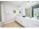 Double vanity bathroom with a large mirror and tile flooring at 8001 Cool Breeze Dr # 121, Orlando, FL 32819