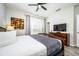 Bright bedroom featuring a king-size bed and a large flat-screen TV at 8001 Cool Breeze Dr # 121, Orlando, FL 32819