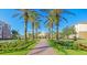 Resort entrance with palm trees and landscaping at 8001 Cool Breeze Dr # 121, Orlando, FL 32819