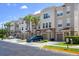Modern townhouses with attached garages and palm trees at 8001 Cool Breeze Dr # 121, Orlando, FL 32819