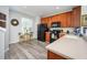 Modern kitchen with wood cabinets and black appliances at 8001 Cool Breeze Dr # 121, Orlando, FL 32819