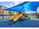Shaded playground with slides and play structures at 8001 Cool Breeze Dr # 121, Orlando, FL 32819