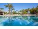 Inviting pool reflecting the surrounding palms at 8001 Cool Breeze Dr # 121, Orlando, FL 32819