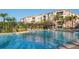 Large community pool with palm trees and building at 8001 Cool Breeze Dr # 121, Orlando, FL 32819