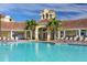 Community pool with plenty of lounge chairs for relaxing at 8001 Cool Breeze Dr # 121, Orlando, FL 32819
