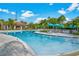 Large resort-style pool with lounge chairs and umbrellas at 8001 Cool Breeze Dr # 121, Orlando, FL 32819