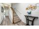 Modern staircase with wood railing and gray floors at 8001 Cool Breeze Dr # 121, Orlando, FL 32819