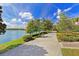 Scenic walking path along the lake with beautiful landscaping at 8001 Cool Breeze Dr # 121, Orlando, FL 32819