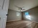 Bright, empty bedroom with light wood floors and a ceiling fan at 904 Avenue A, Haines City, FL 33844