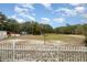 Spacious backyard with white fence and shed at 9151 Sw 157Th Ln, Dunnellon, FL 34432