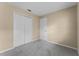 Unfurnished bedroom featuring double closet doors and plush carpeting at 955 Northern Dancer Way # 203, Casselberry, FL 32707