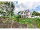 View of a two-story home from the backyard garden at 1413 Dorothy Ave, Haines City, FL 33844