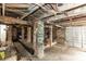 Unfinished basement with exposed brick, wooden beams, and a garage door at 1413 Dorothy Ave, Haines City, FL 33844