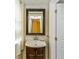 Bathroom vanity with sink, mirror, and marble tile at 1413 Dorothy Ave, Haines City, FL 33844