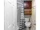Small bathroom featuring a shower, toilet, and storage cabinet at 1413 Dorothy Ave, Haines City, FL 33844