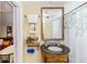 Bathroom with a vanity sink, mirror, and patterned shower curtain at 1413 Dorothy Ave, Haines City, FL 33844