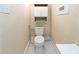 Toilet in a small, minimalist bathroom with marble tile flooring at 1413 Dorothy Ave, Haines City, FL 33844