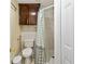 Bathroom with shower, toilet, and dark wood storage cabinet at 1413 Dorothy Ave, Haines City, FL 33844
