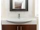 Compact bathroom with a white sink, dark wood vanity, and marble tile at 1413 Dorothy Ave, Haines City, FL 33844