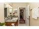 Bathroom with granite countertop, vanity, and view to hallway at 1413 Dorothy Ave, Haines City, FL 33844