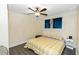 Bedroom with yellow and white checkered bedding, wood floors, and ceiling fan at 1413 Dorothy Ave, Haines City, FL 33844