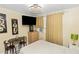 Bedroom furnished with a bed, small dining table, dresser, and TV at 1413 Dorothy Ave, Haines City, FL 33844