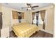 Bedroom with yellow and white checkered bedding, wood floors, and ceiling fan at 1413 Dorothy Ave, Haines City, FL 33844