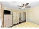 Bedroom with yellow and white checkered bedding, wood floors, and ceiling fan at 1413 Dorothy Ave, Haines City, FL 33844