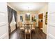 Dining room with glass table, wood floors, and view of the kitchen at 1413 Dorothy Ave, Haines City, FL 33844