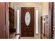 Interior view of the foyer with a brown wooden door, sidelights, and wood-paneled walls at 1413 Dorothy Ave, Haines City, FL 33844