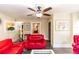 Living room with red leather furniture, ceiling fan, and decorative accents at 1413 Dorothy Ave, Haines City, FL 33844