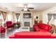 Living area featuring red furniture, a fireplace, and large windows with curtains at 1413 Dorothy Ave, Haines City, FL 33844