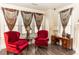 Cozy sitting area with red armchairs, decorative lamps, and a small table at 1413 Dorothy Ave, Haines City, FL 33844